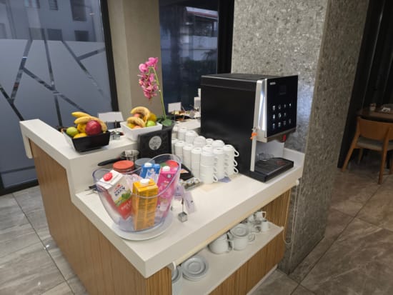 a coffee machine and fruit on a counter