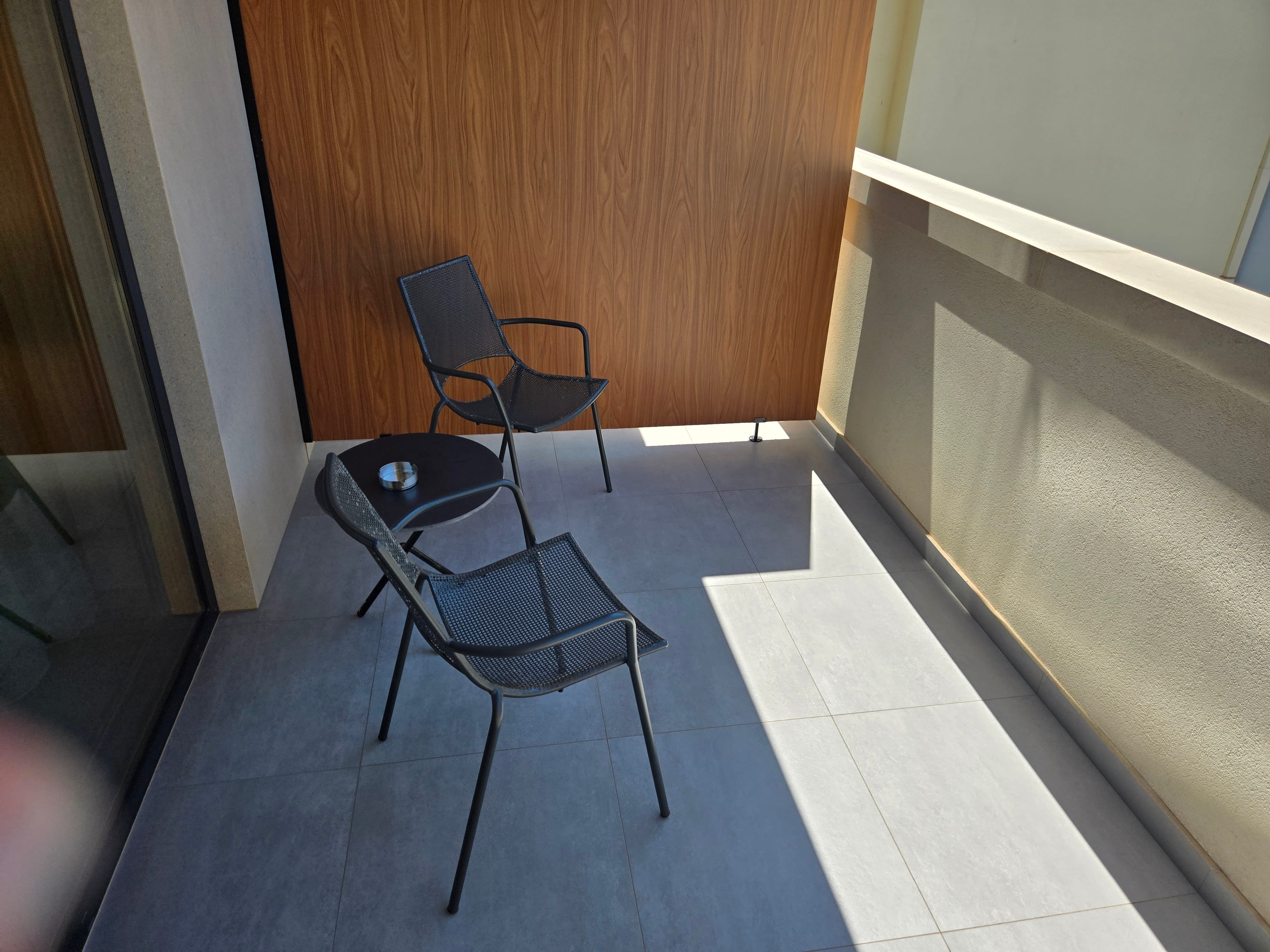 a chair and table on a balcony