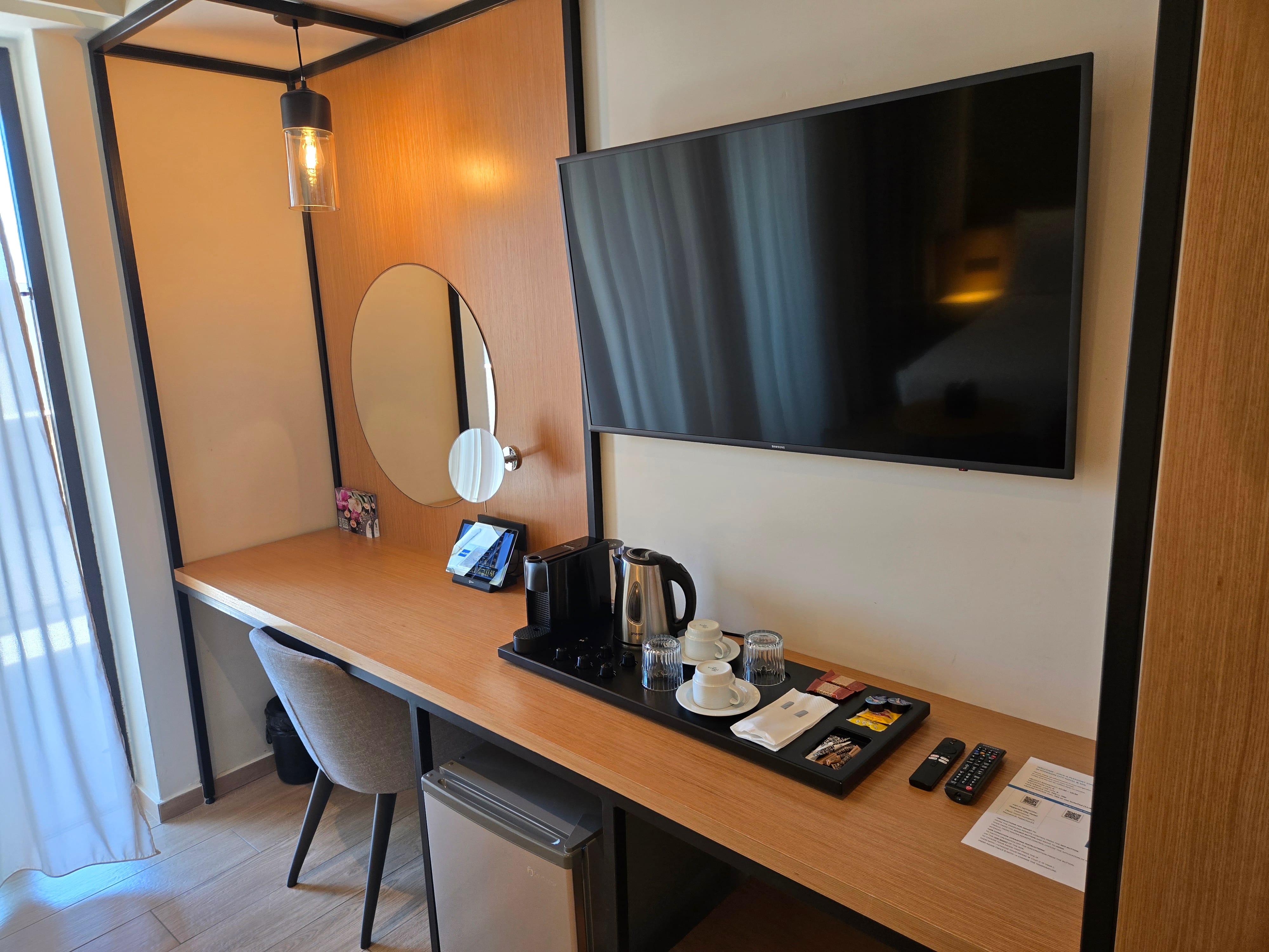 a room with a television and a mirror