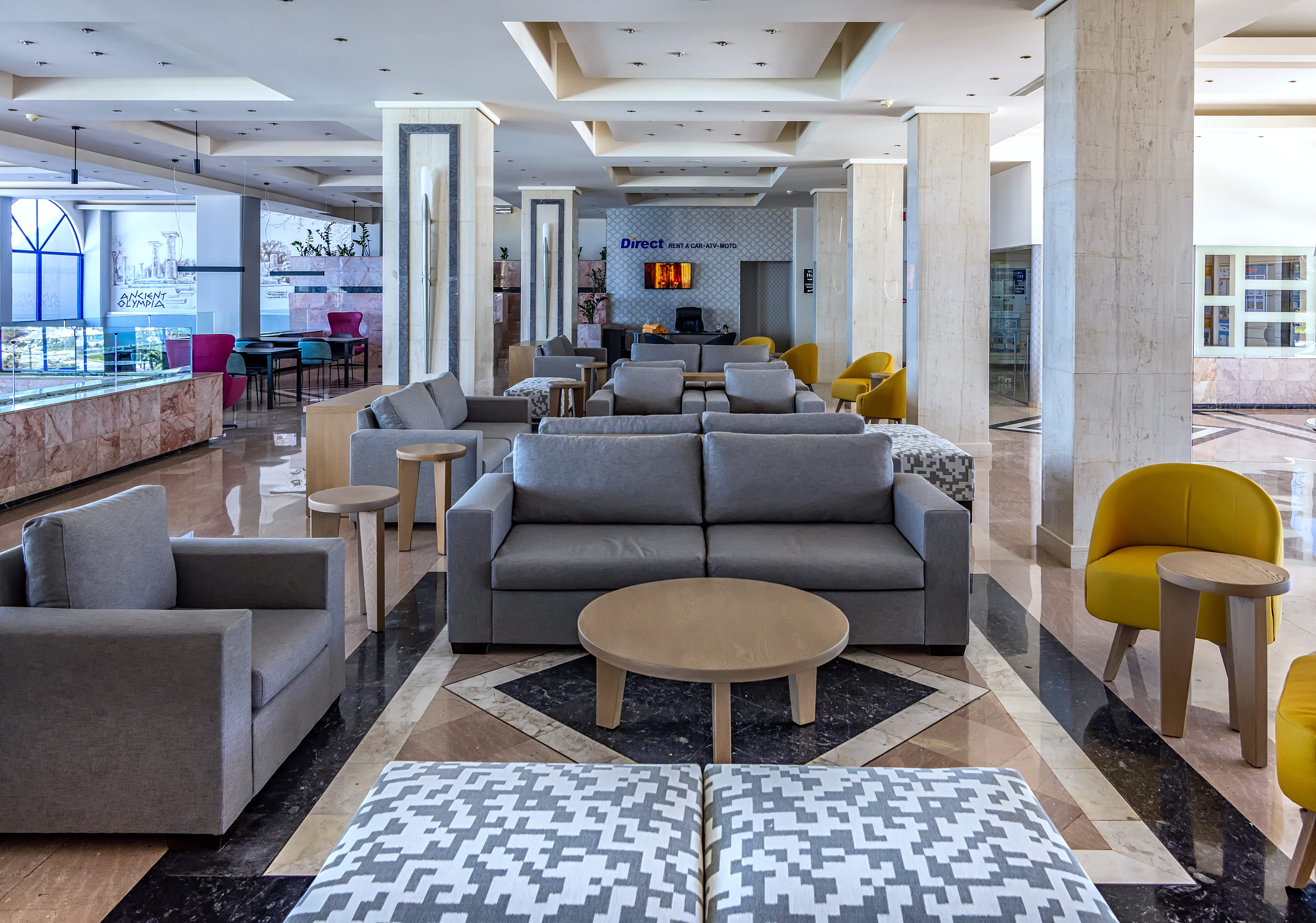 a room with a couch and chairs