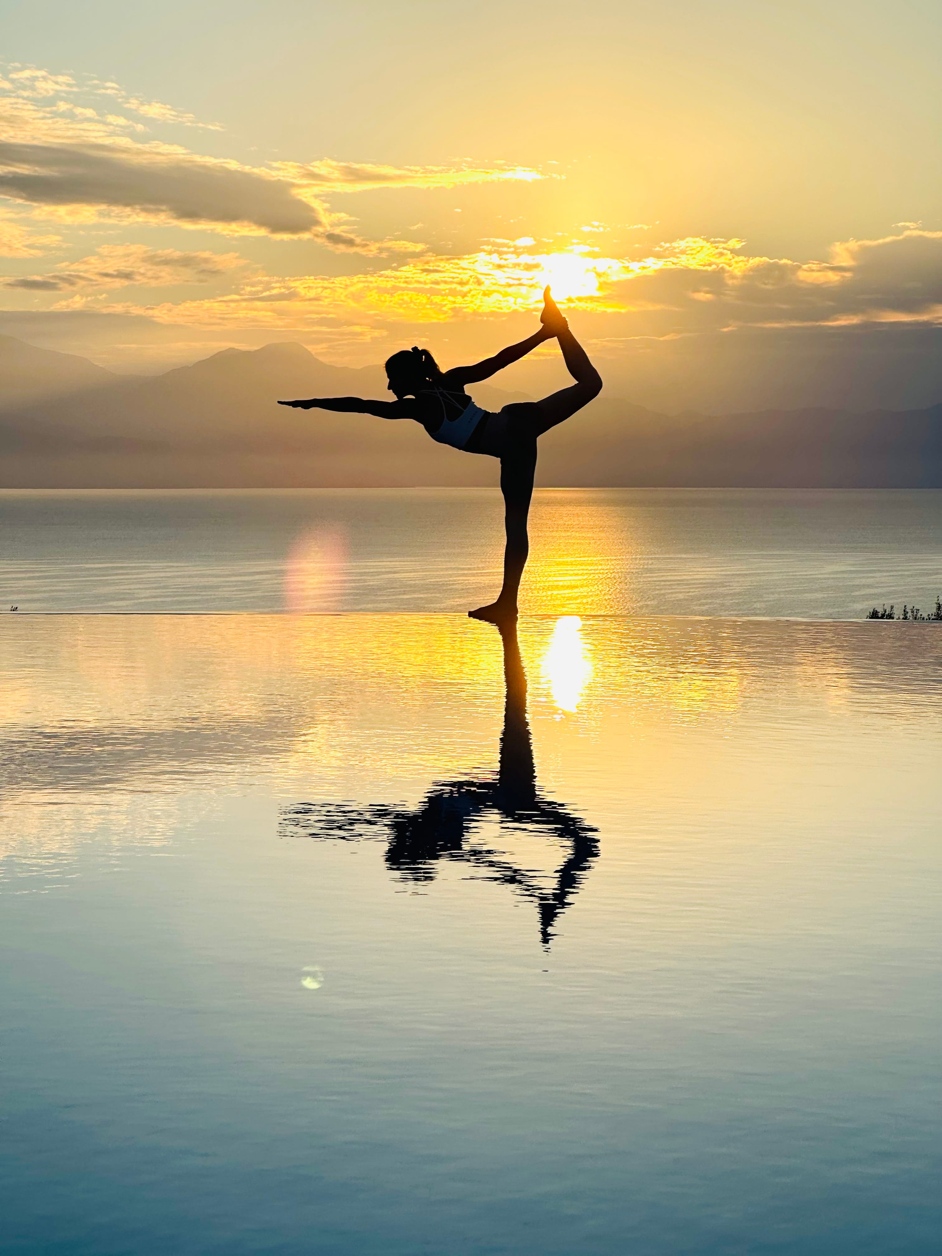 a person doing a handstand on a beach