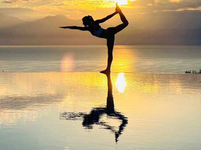 a person doing a handstand on a beach