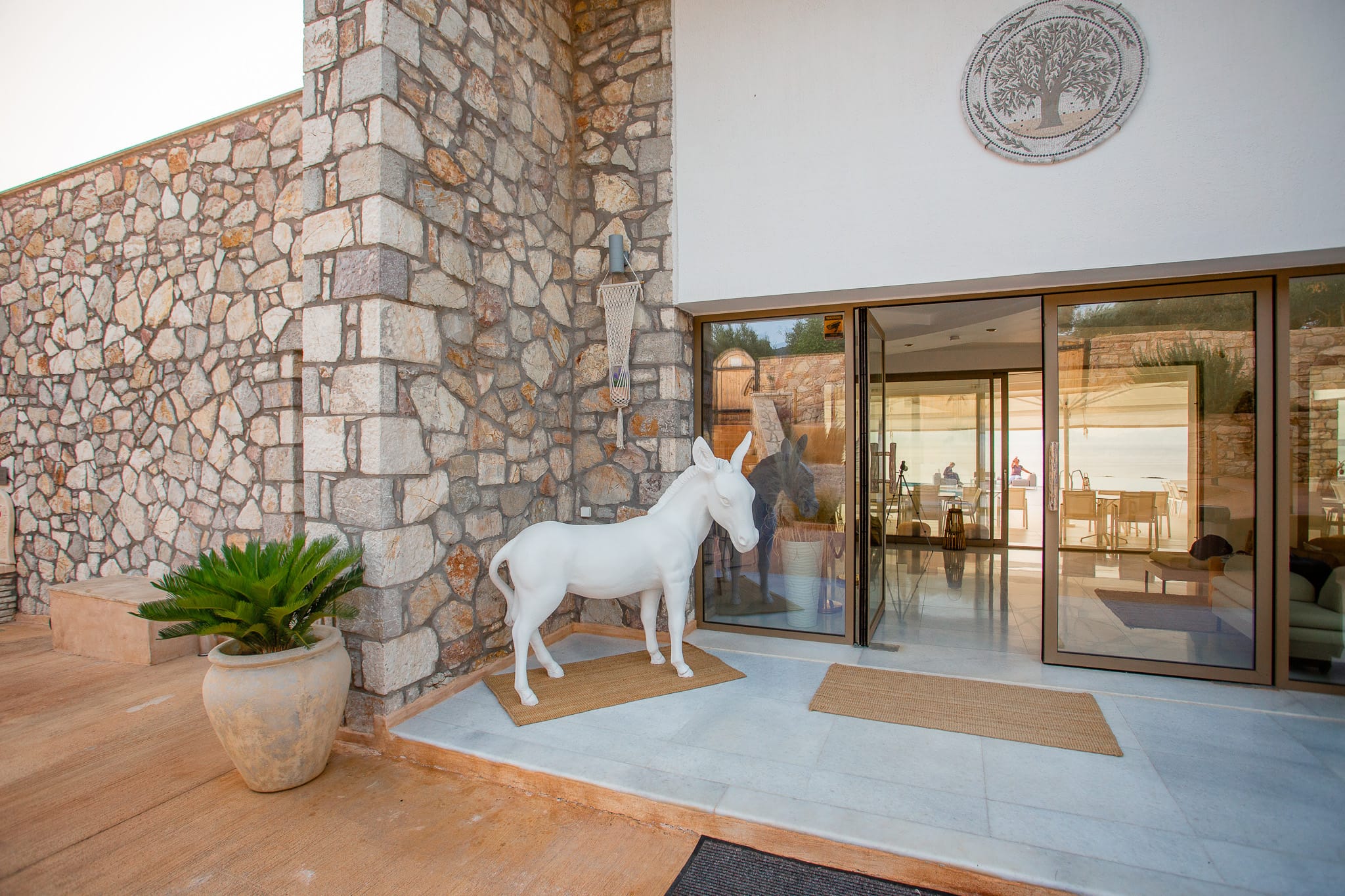 a statue of a horse in a room with glass walls