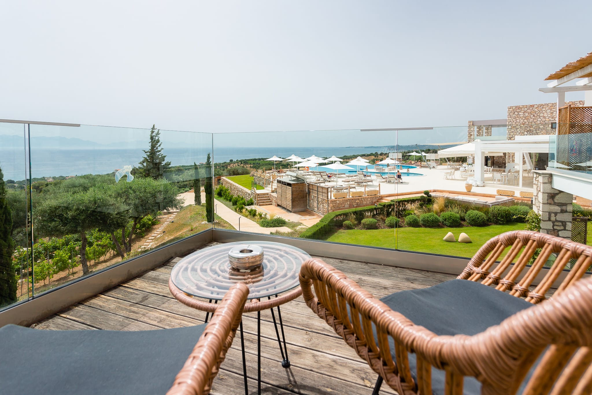 a patio with a table and chairs overlooking a beach