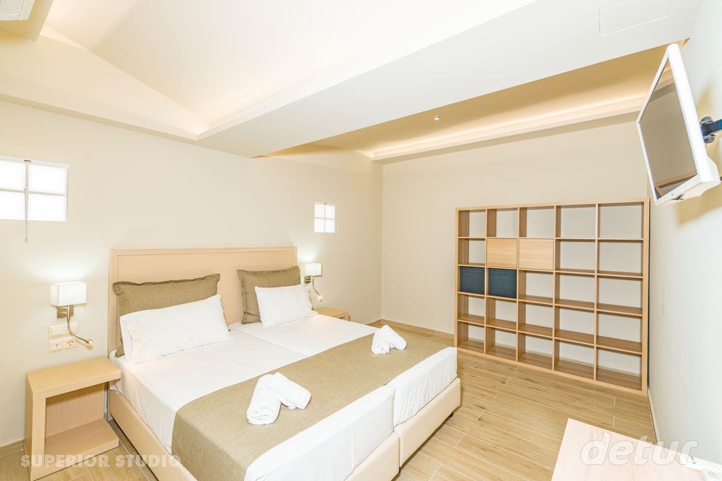 a hotel room with a bed and television