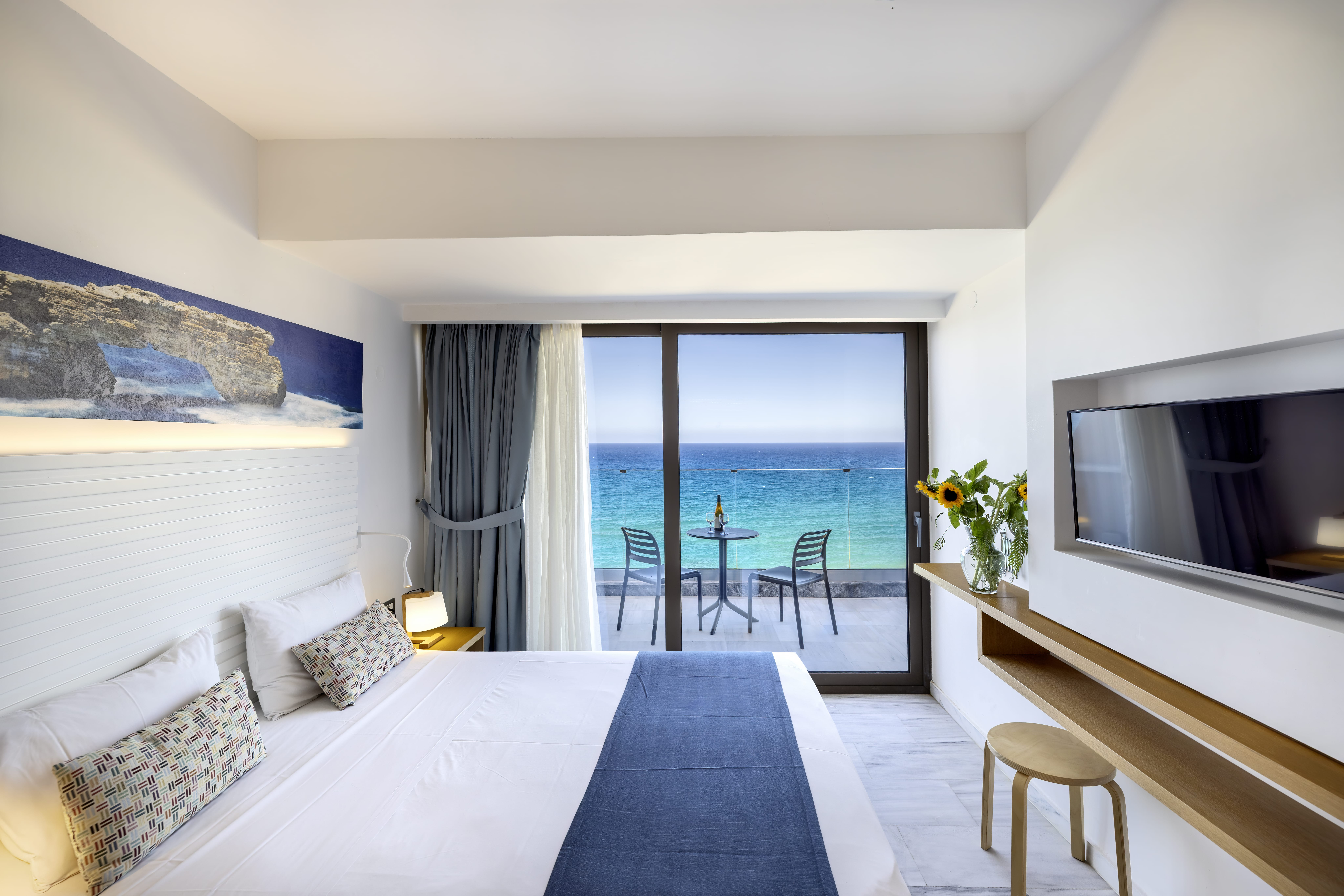 a bedroom with a view of the ocean