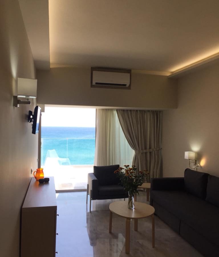 a living room with a view of the ocean