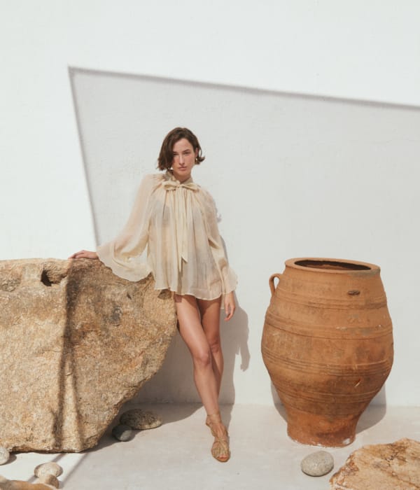 a person standing next to a vase