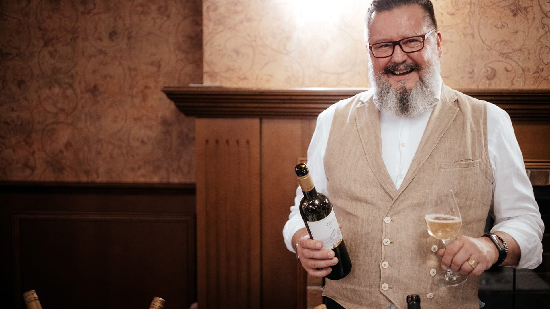 a man holding a bottle of wine