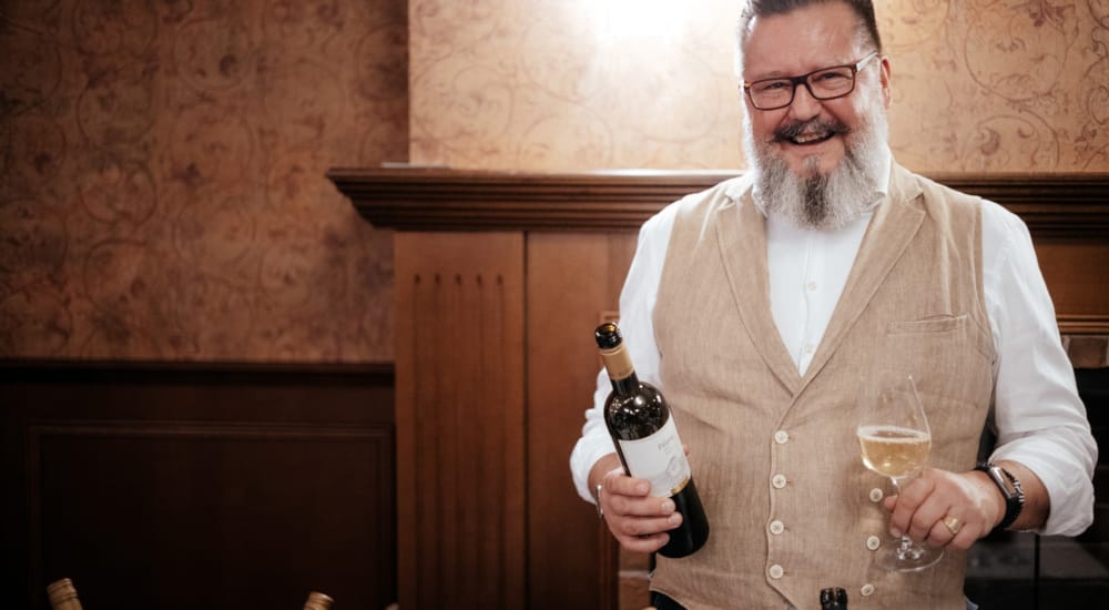 a man holding a bottle of wine