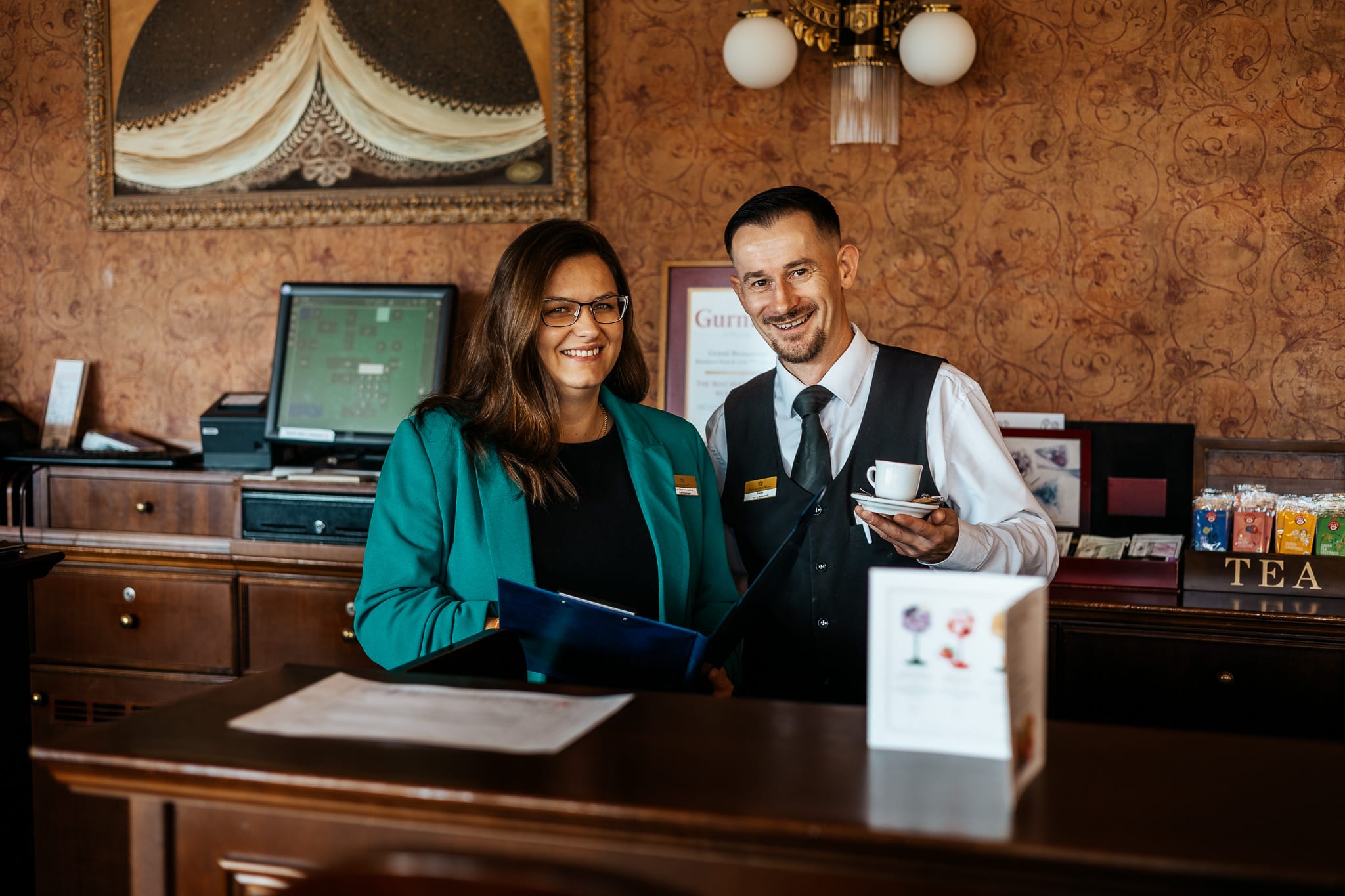 a person and person standing behind a desk