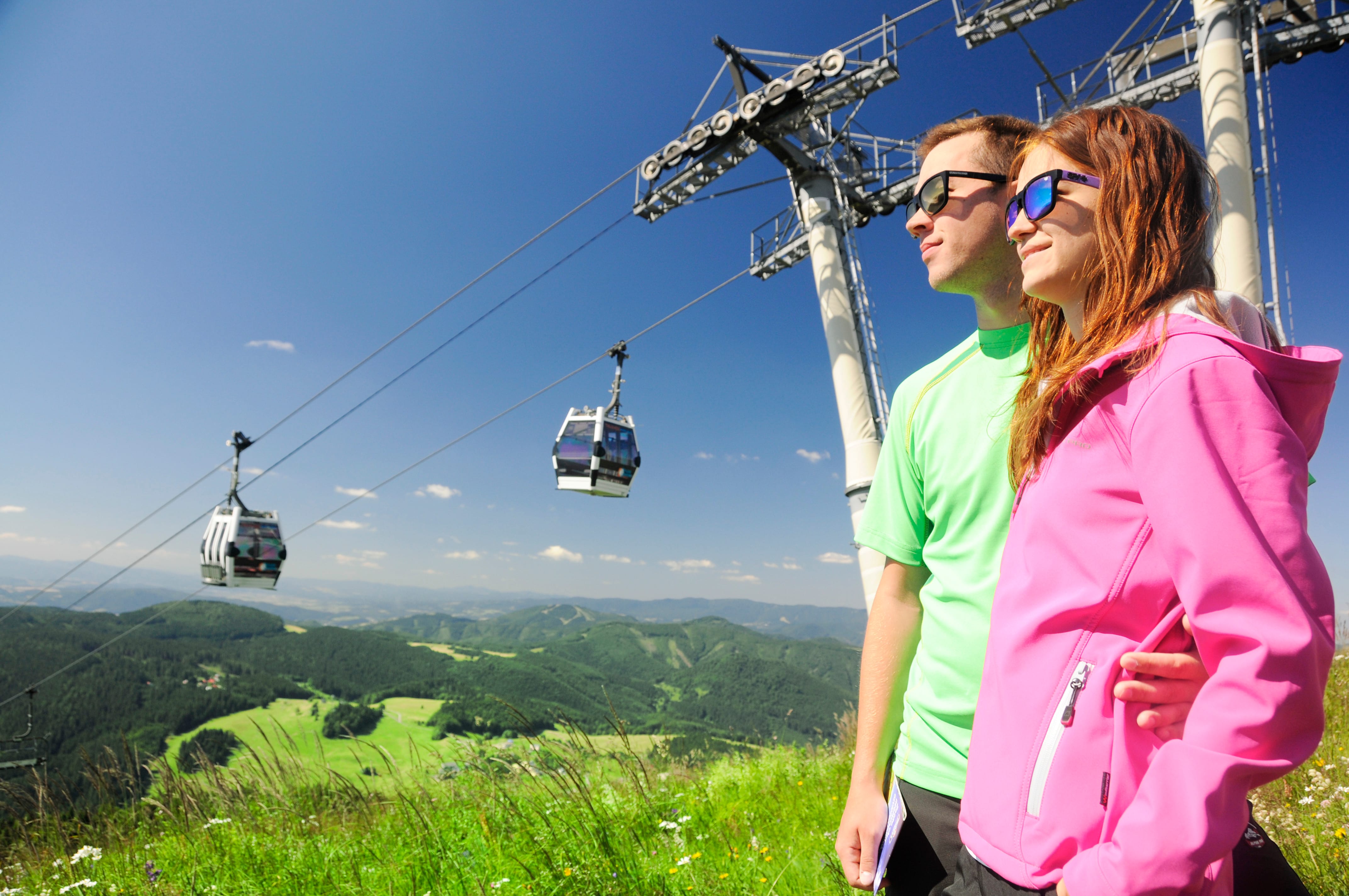 a man and woman on a cable car
