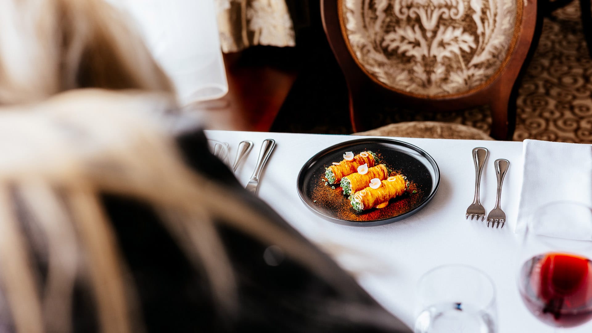 a plate of food and a glass of wine