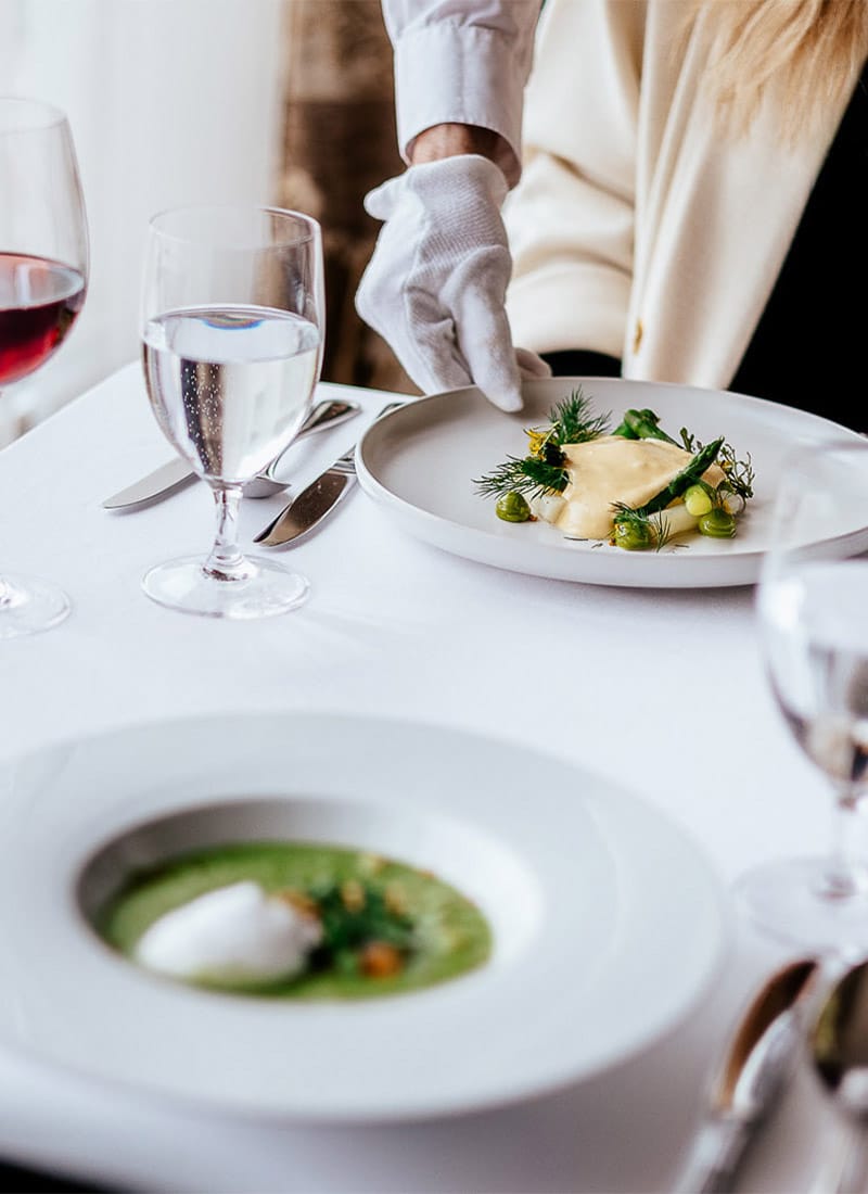 a table with plates of food and glasses of wine