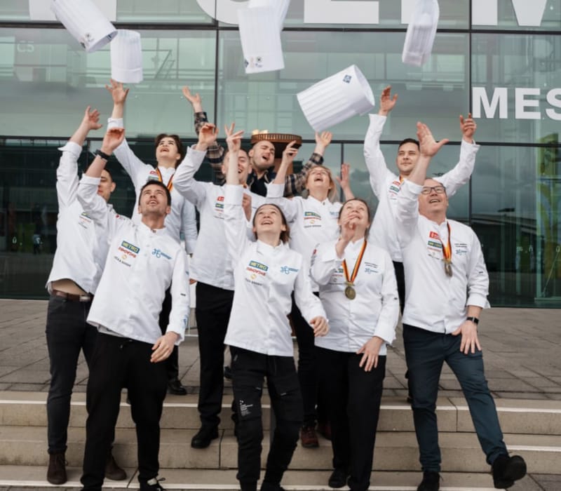 a group of people holding up paper
