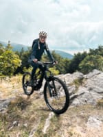 a man riding a bike on a rocky trail