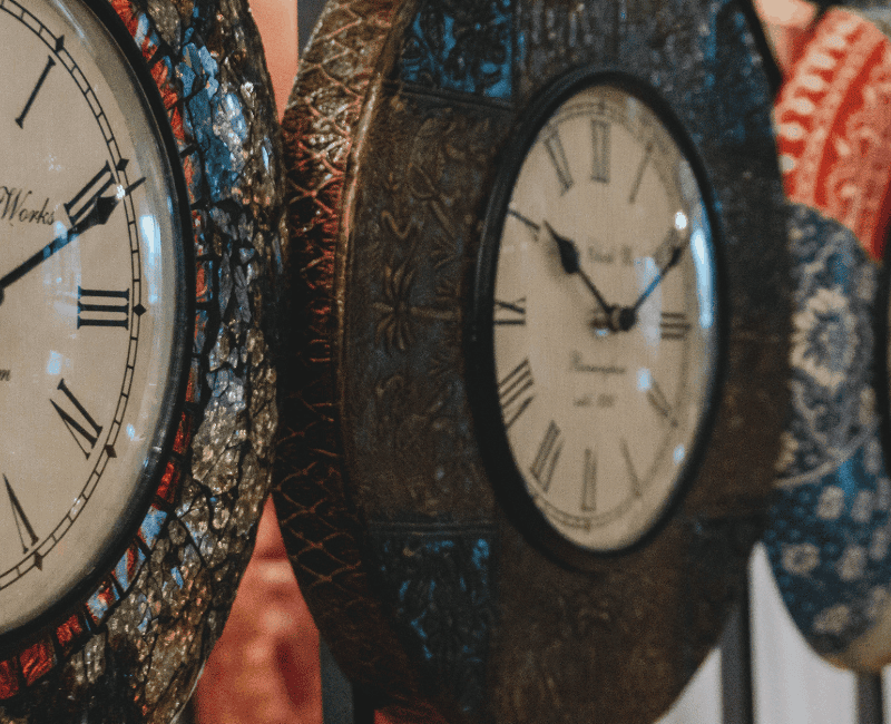 a group of clocks on a wall