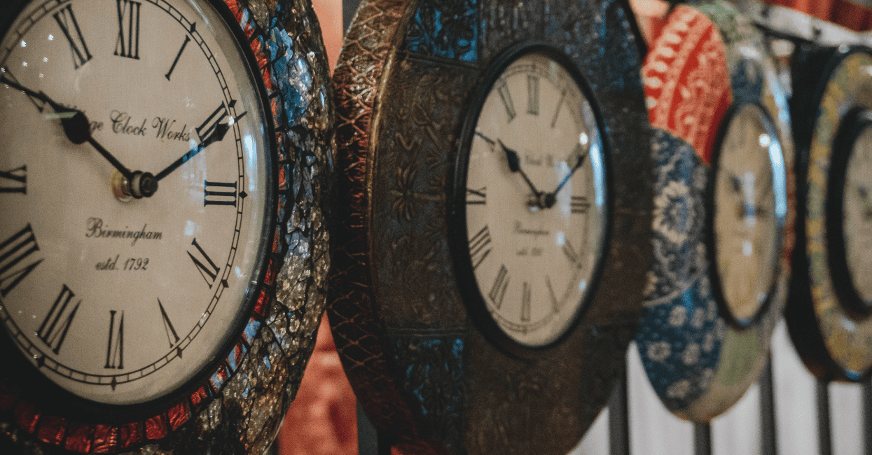 a group of clocks on a wall