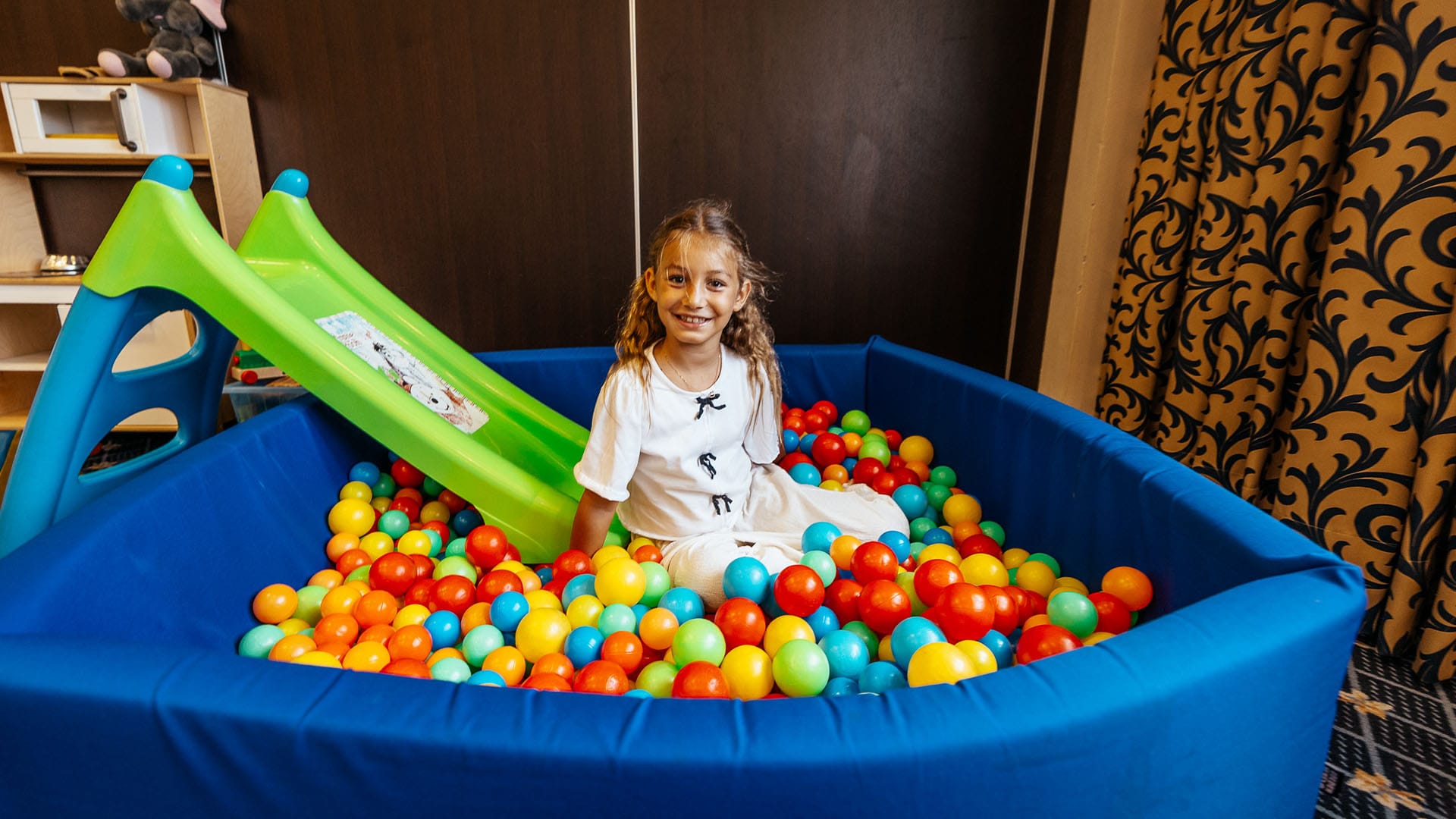 a girl in a ball pit