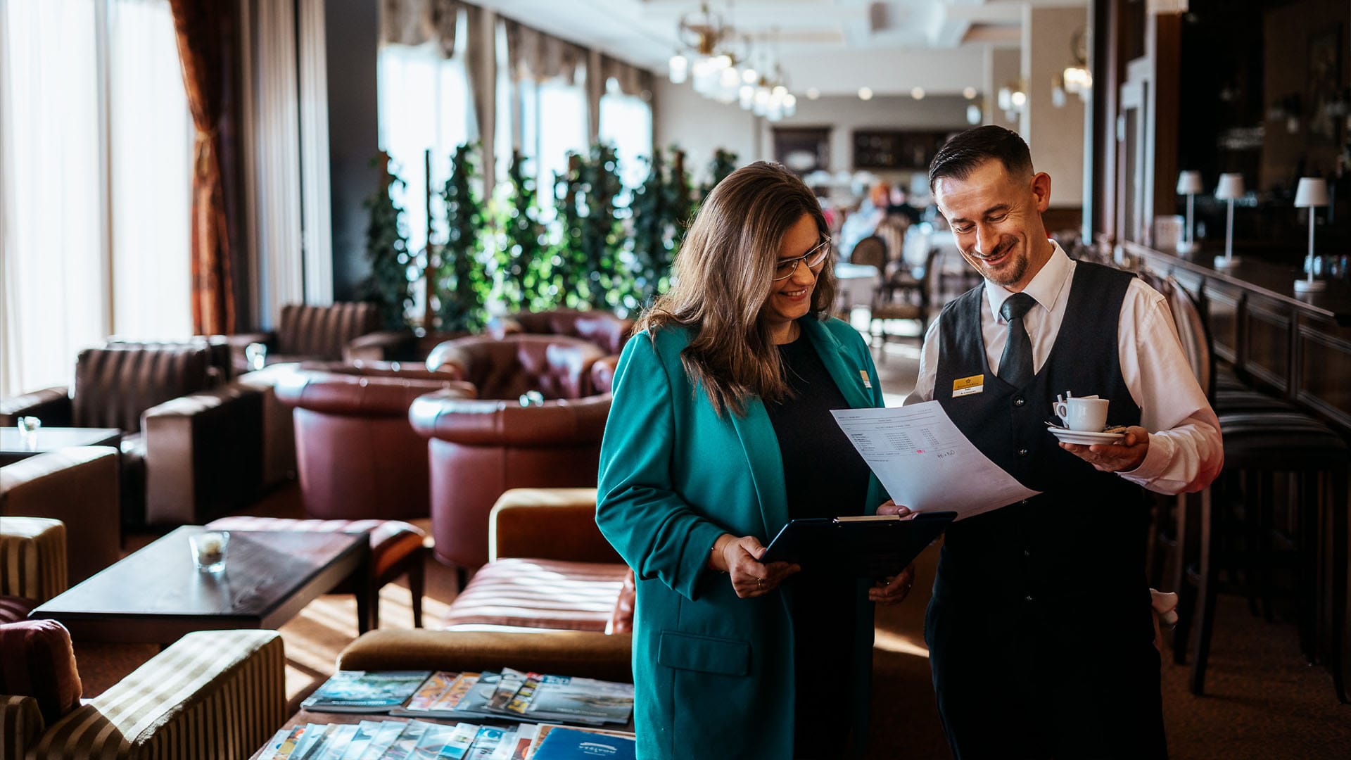 a man and a woman looking at a paper