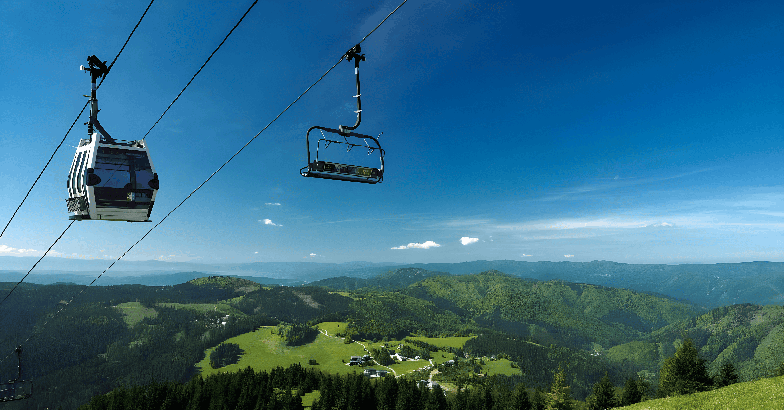 a chair lift above a forest