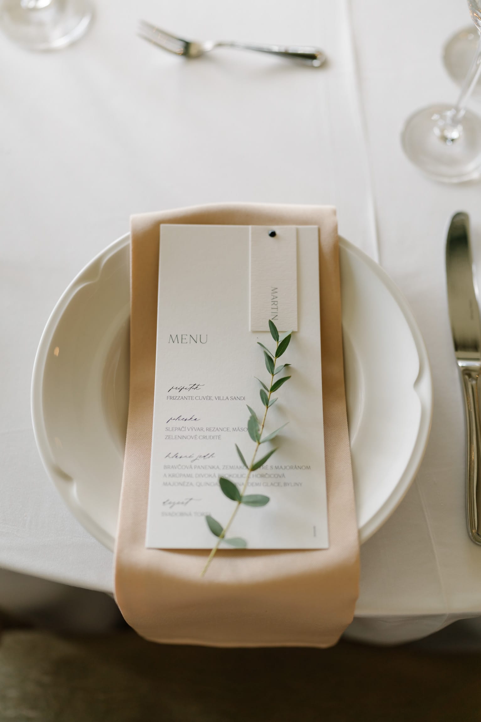 a white plate with a green leaf on it