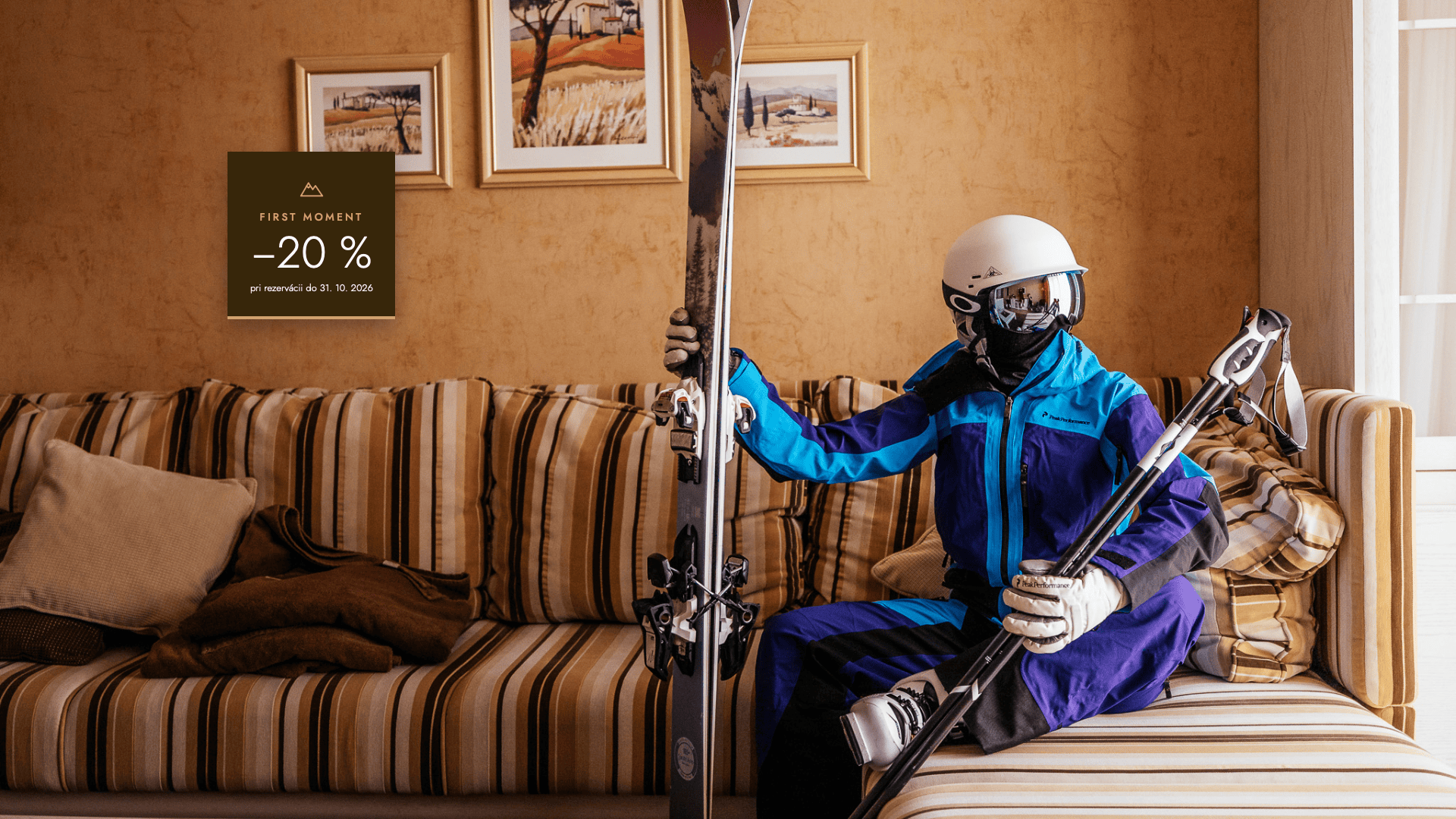 a person in a ski suit holding a pair of skis