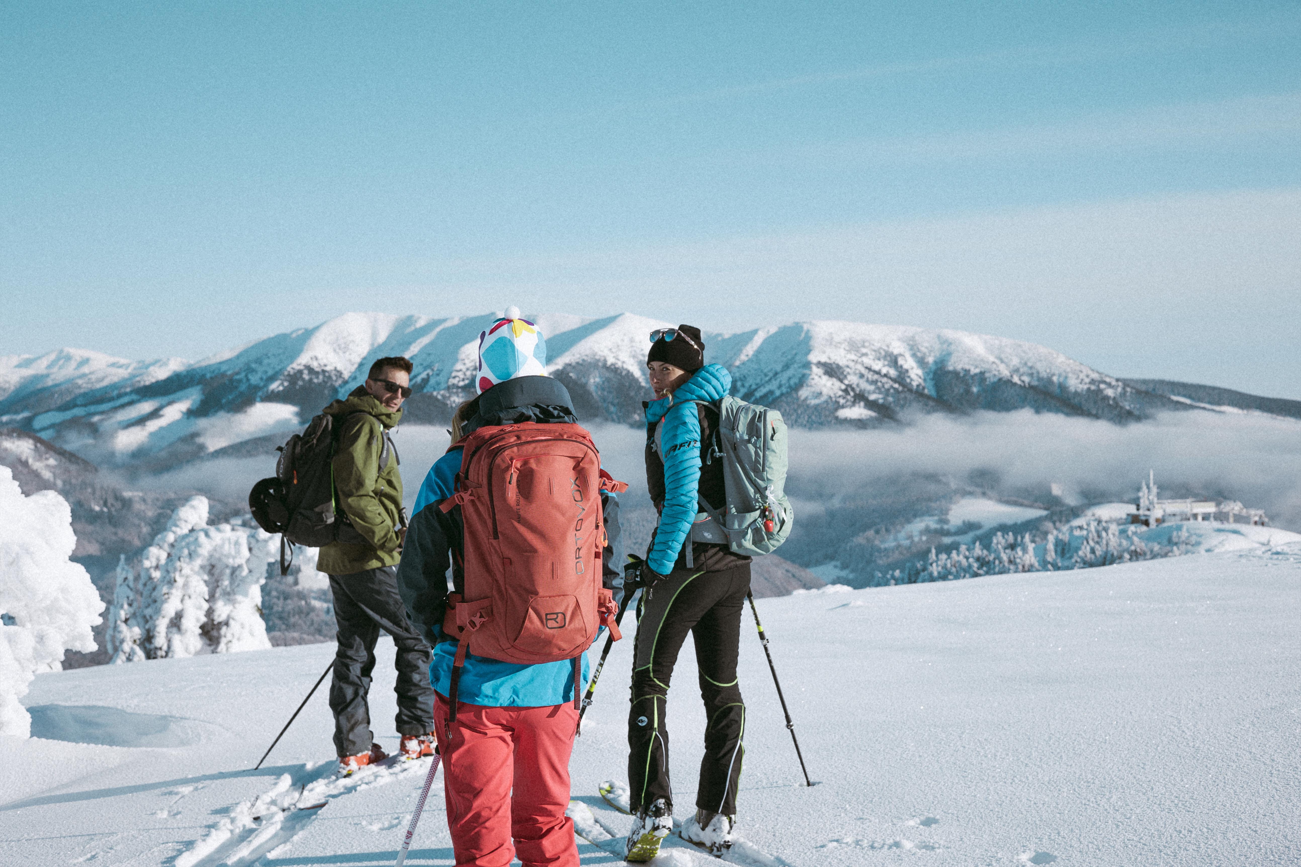 a group of skiers on top of a mountain