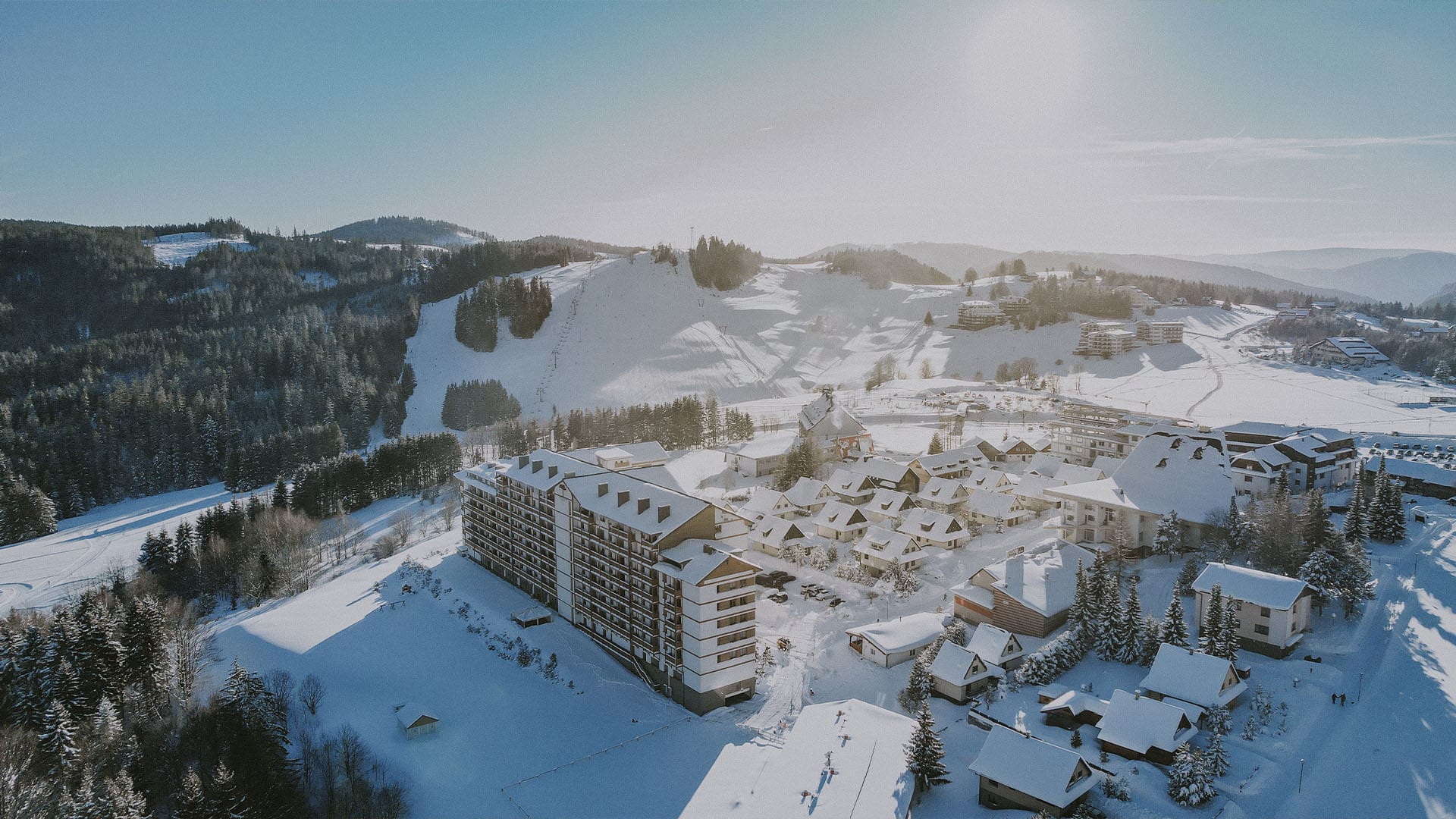 a large building surrounded by snow