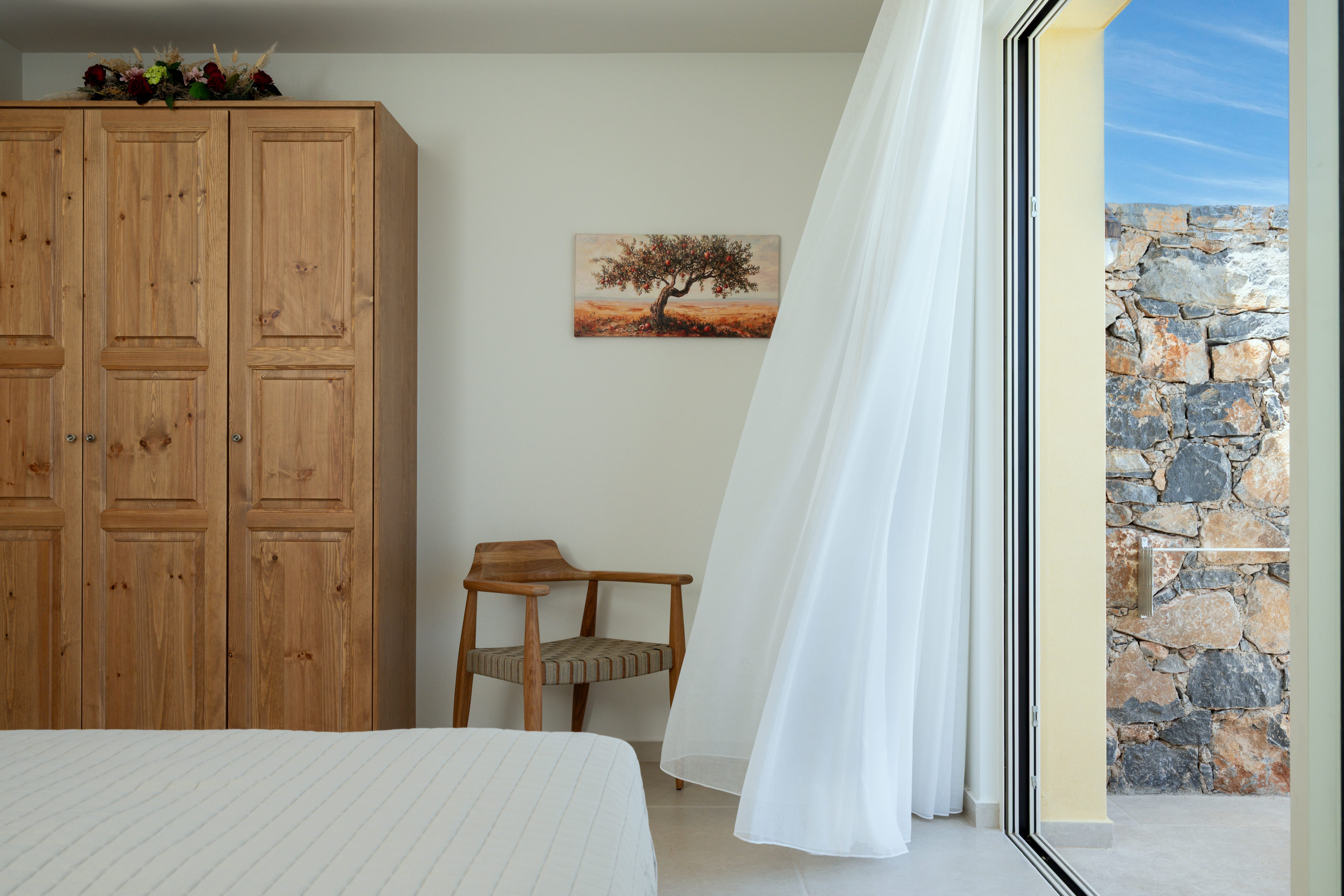 a bedroom with a bed and a chair
