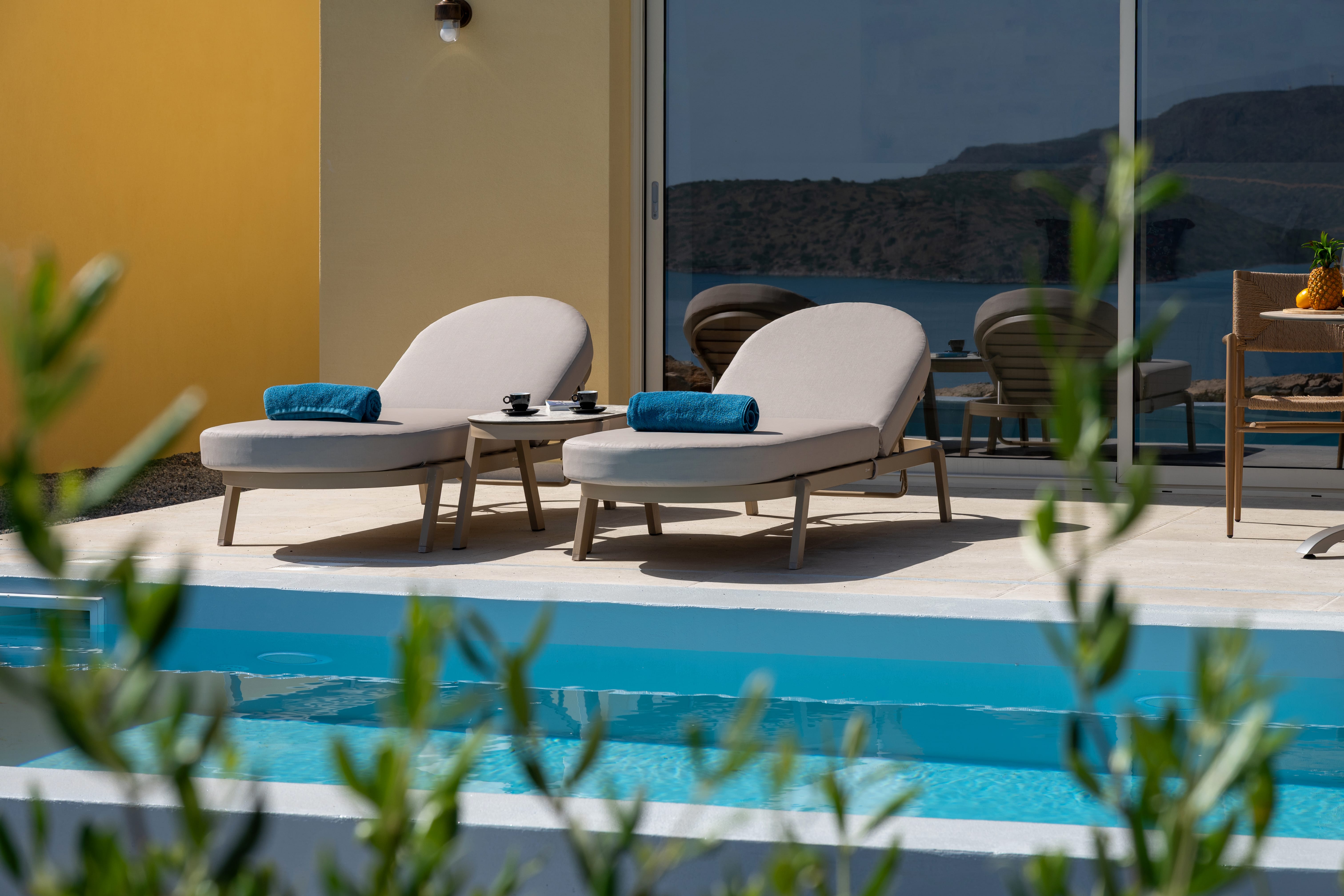 a pool with lounge chairs and a table