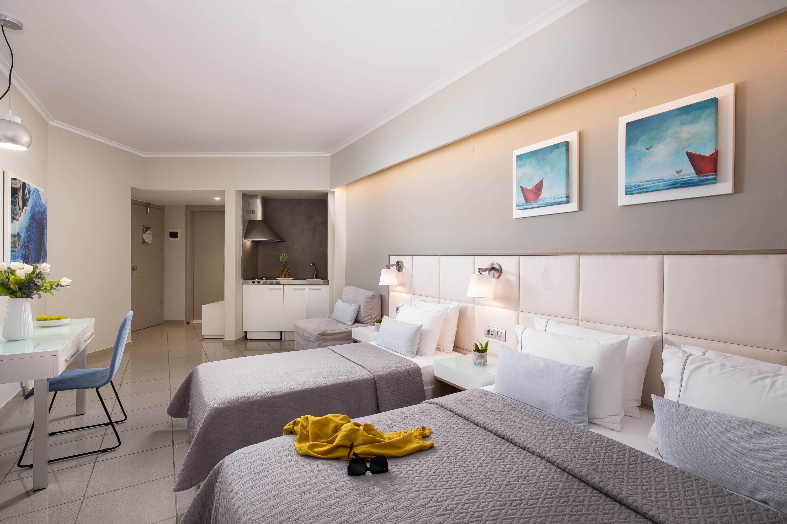 a large bedroom with white couches