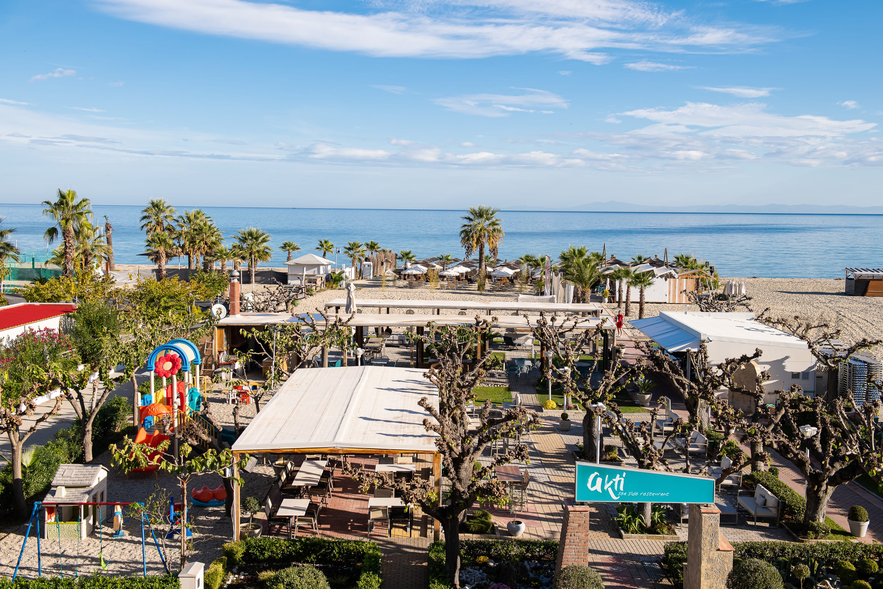 a beach with trees and buildings