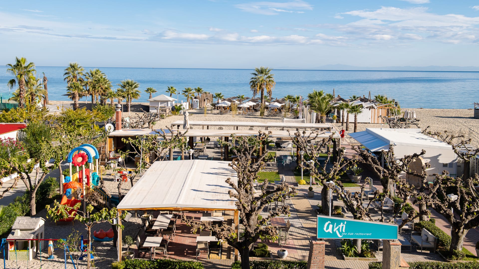 a beach with trees and buildings