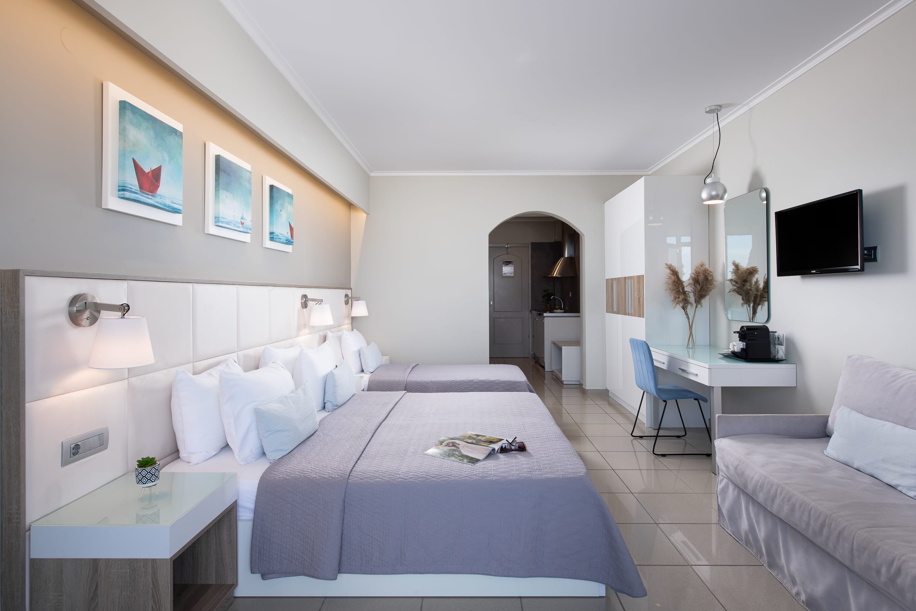 a large bedroom with a bed and a tv