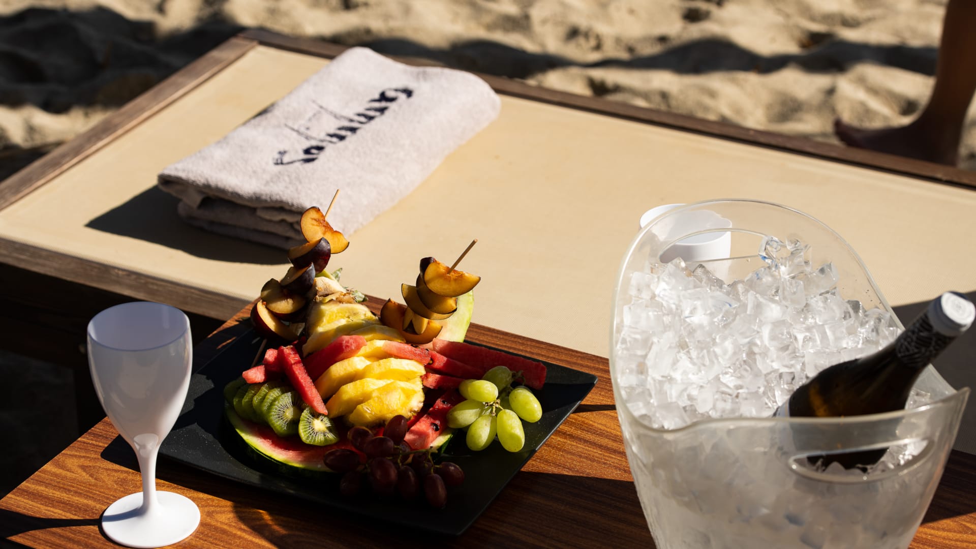 a bowl of fruit and a glass of water on a table