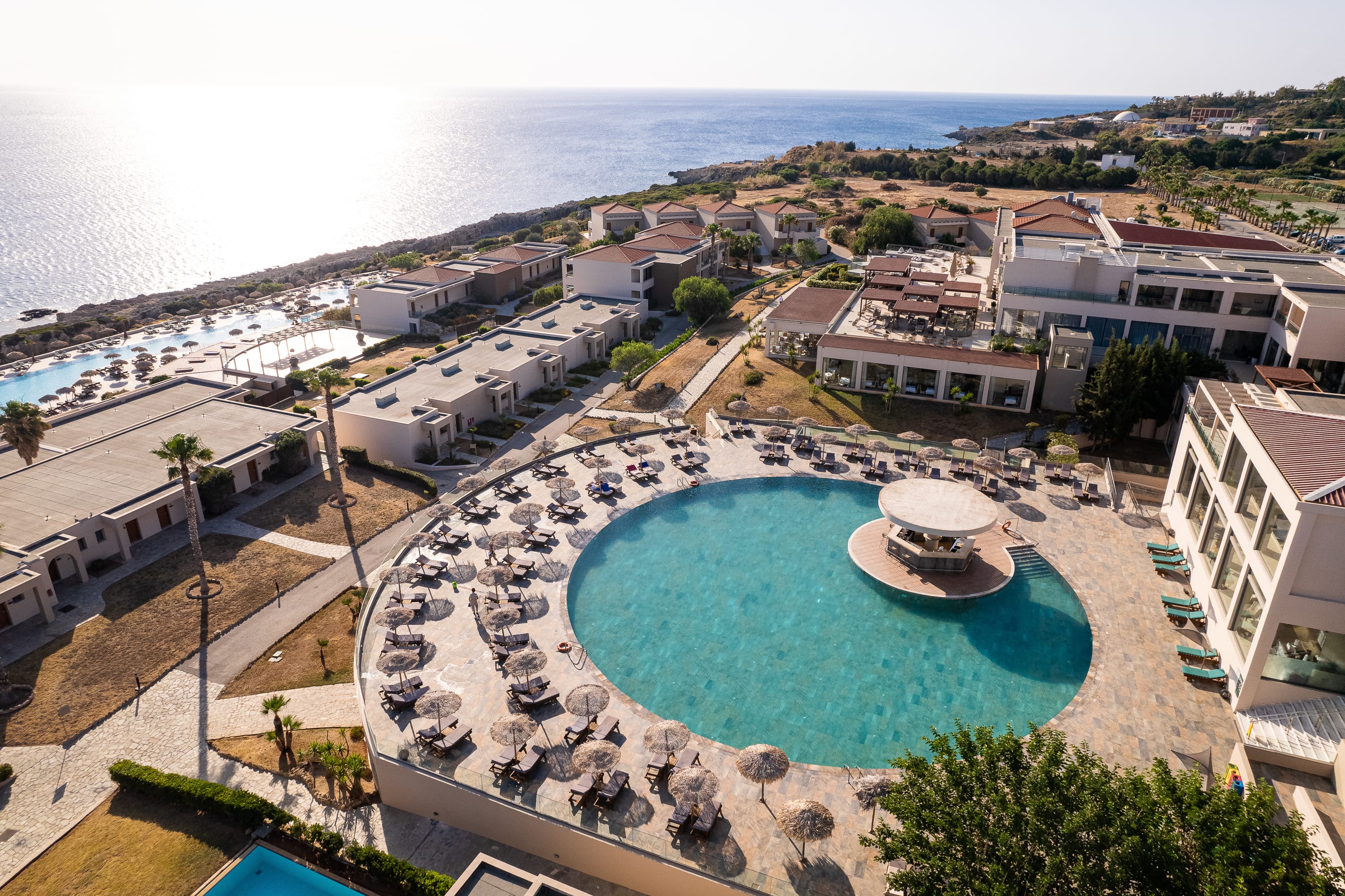 a pool surrounded by buildings and trees