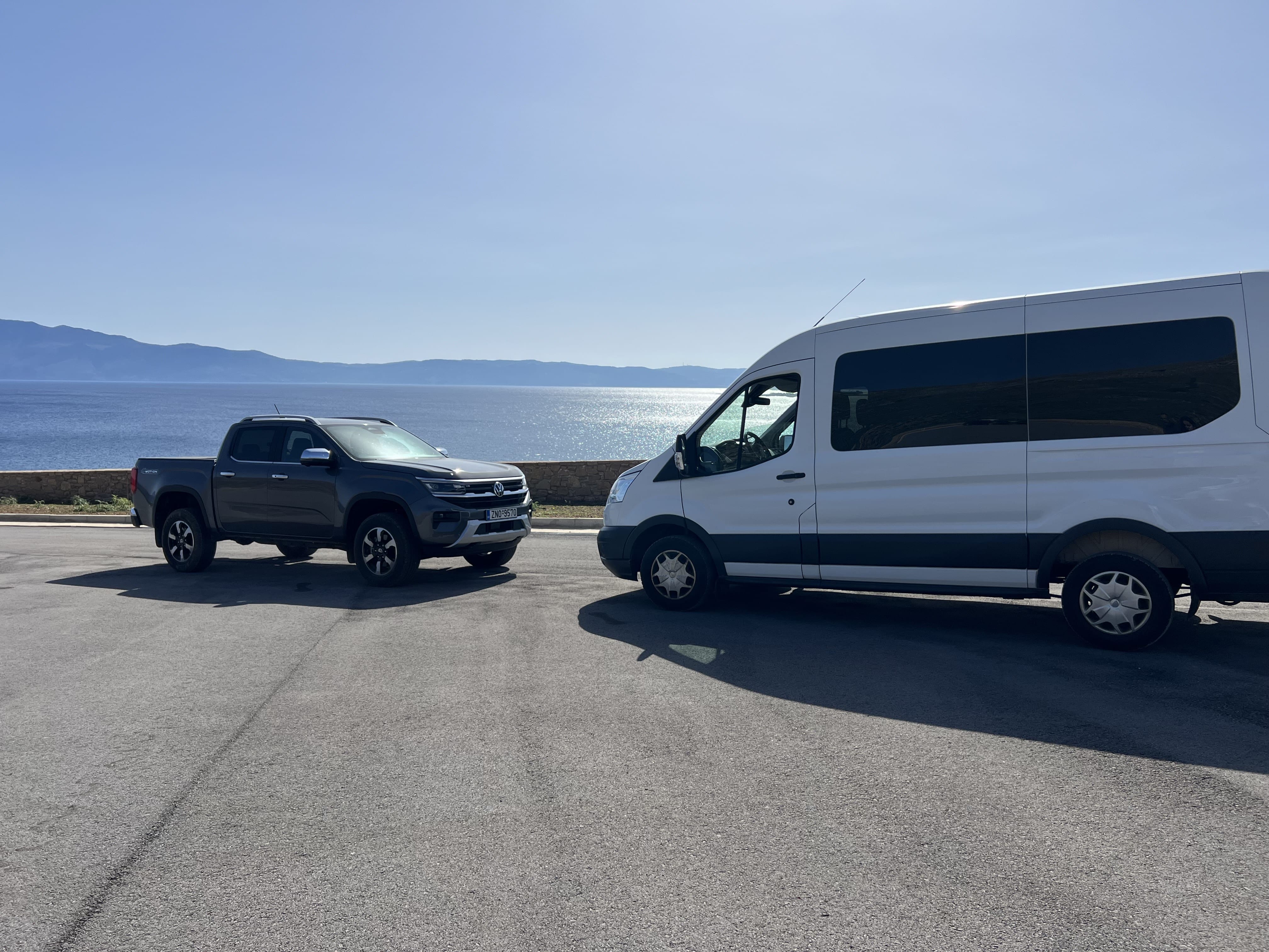 a car and a van parked on a road