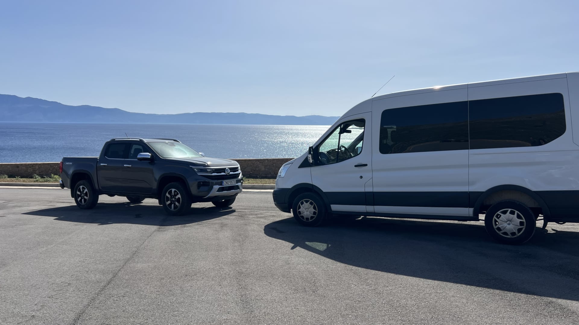 a car and a van parked on a road