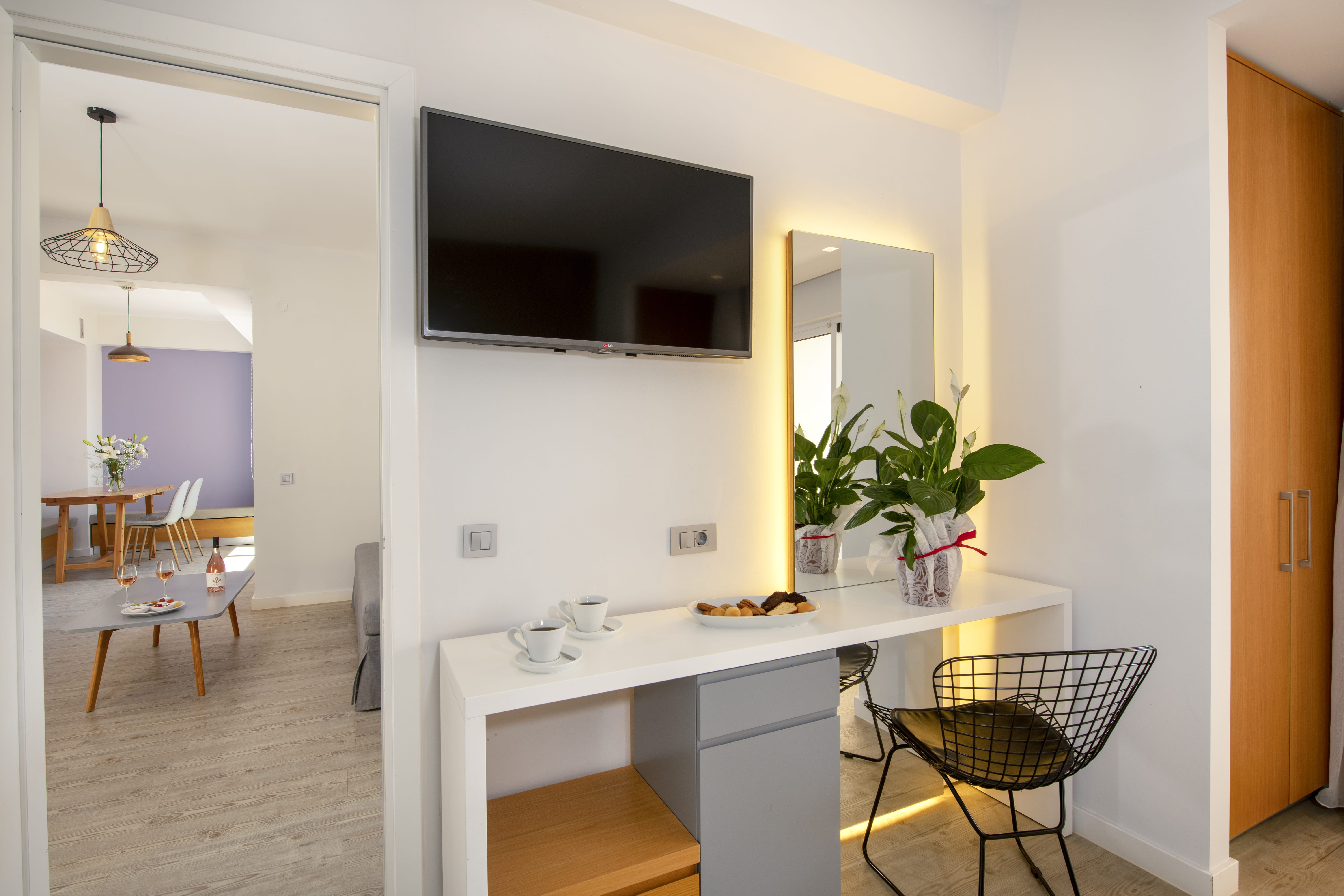 a room with a tv and chairs