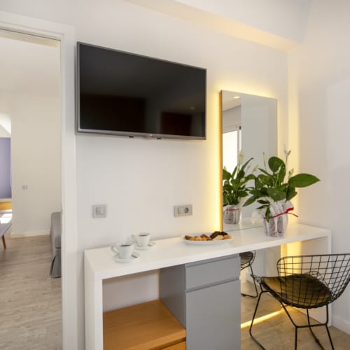 a room with a tv and chairs