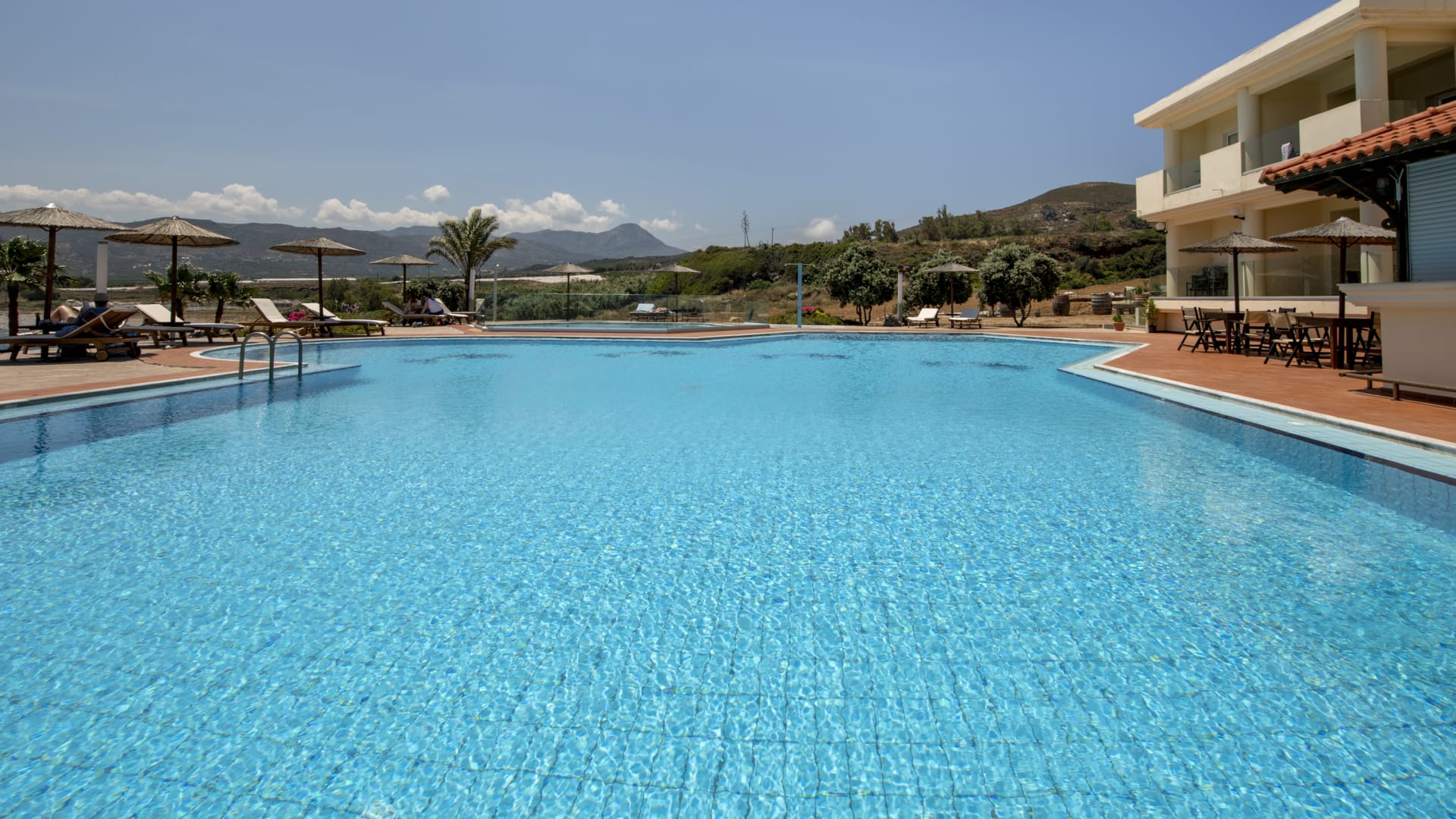 a pool with a building in the background