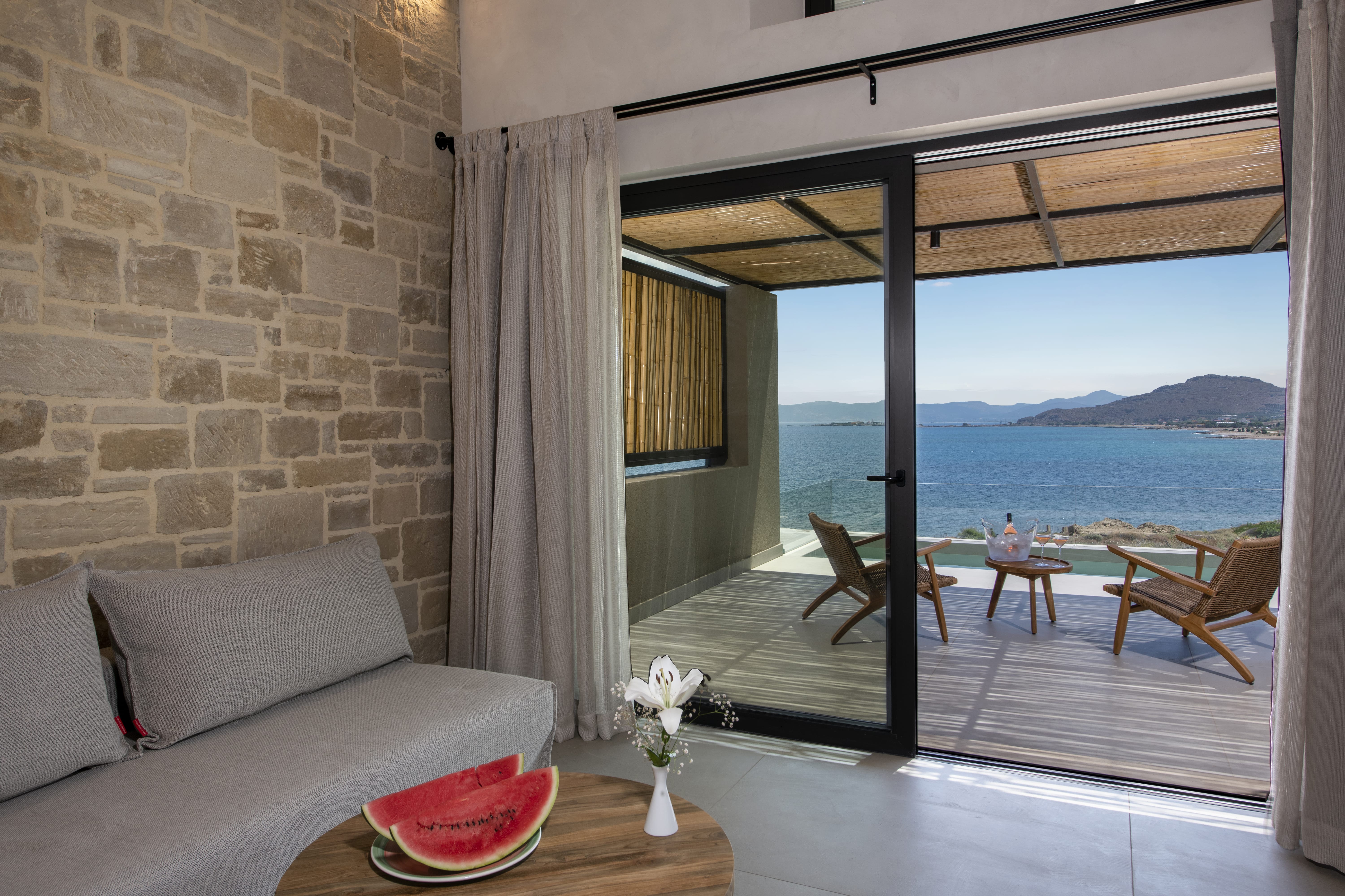 a living room with a view of the ocean