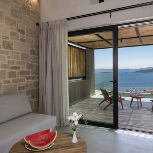 a living room with a view of the ocean