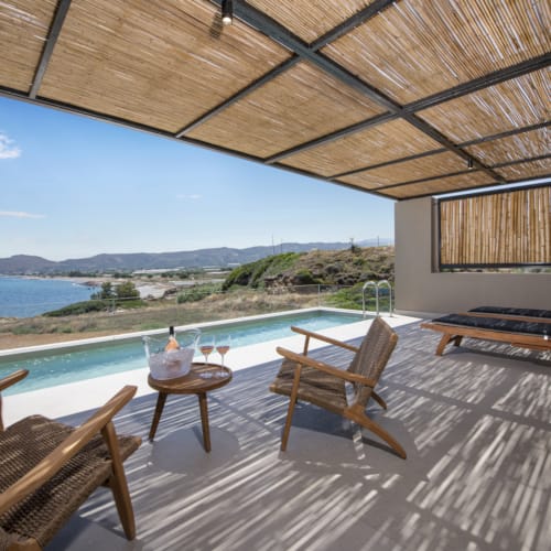 a deck with chairs and a table