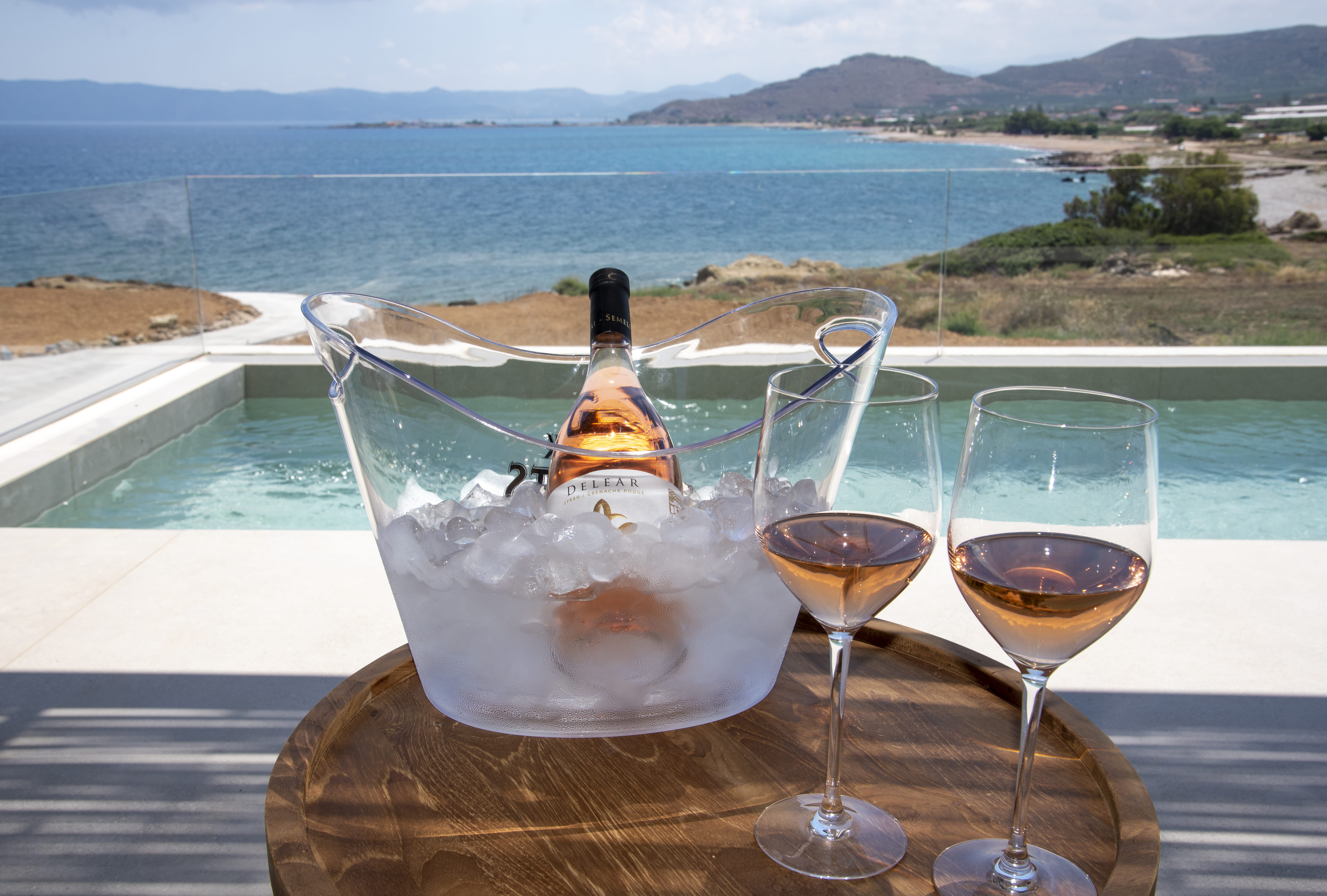 a table with glasses of wine and a bottle of wine on it