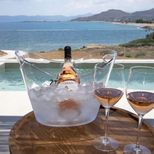 a table with glasses of wine and a bottle of wine on it