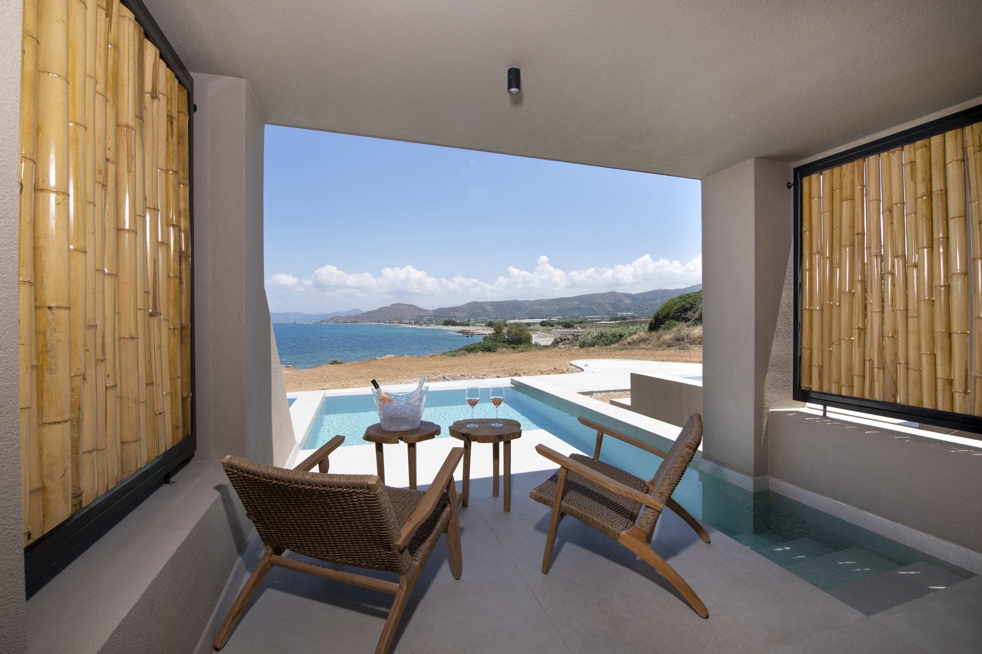 a room with a table chairs and a painting on the wall