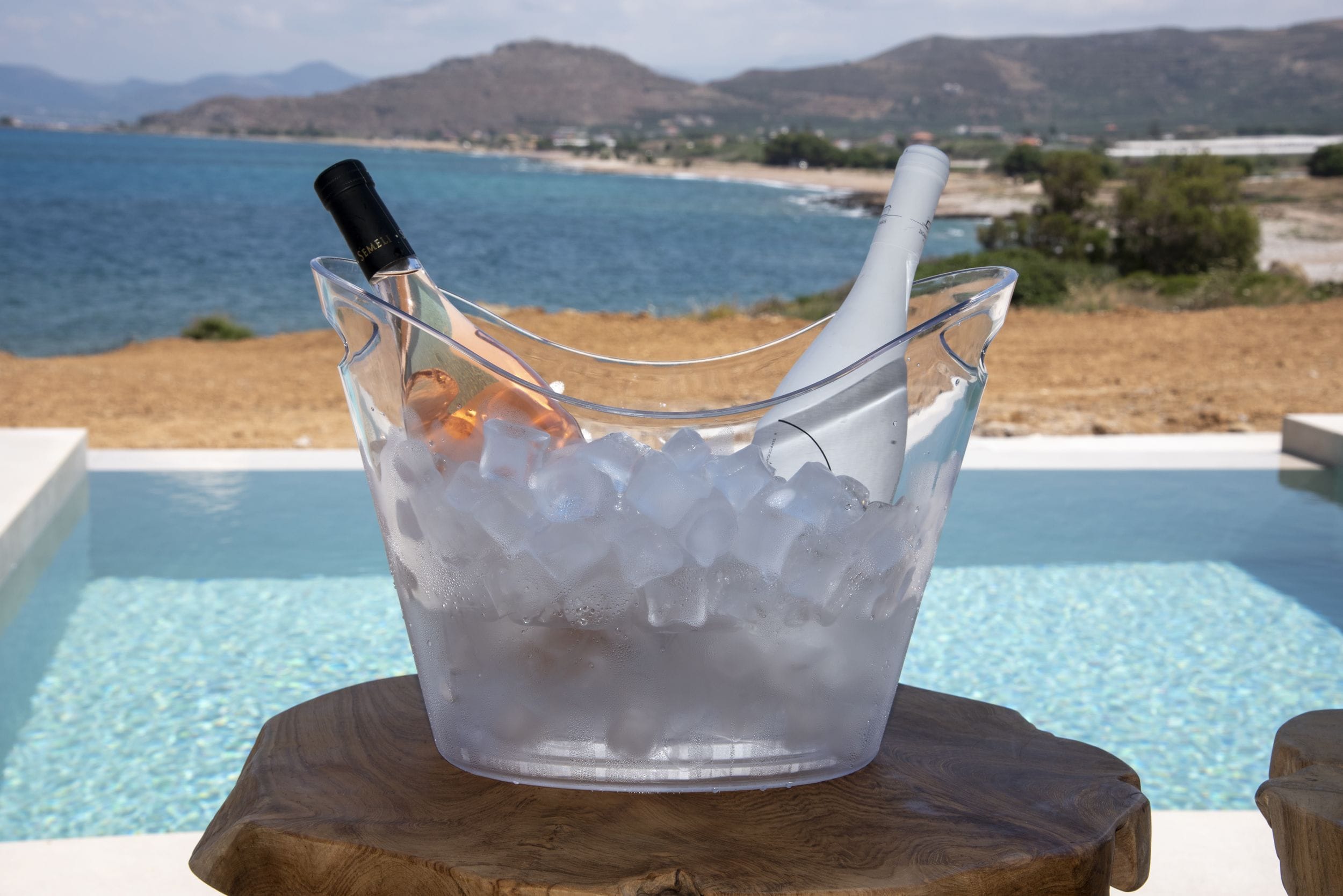 a glass bowl with ice and a straw in it
