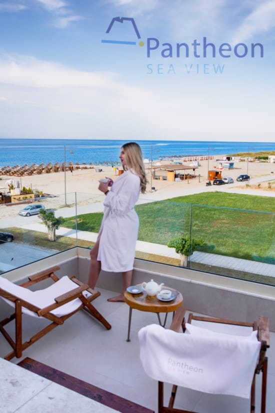 a person standing on a balcony overlooking a beach and ocean